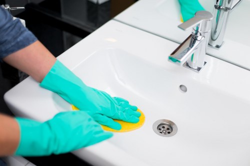 Technician cleaning a sofa in a Brixton property with careful equipment